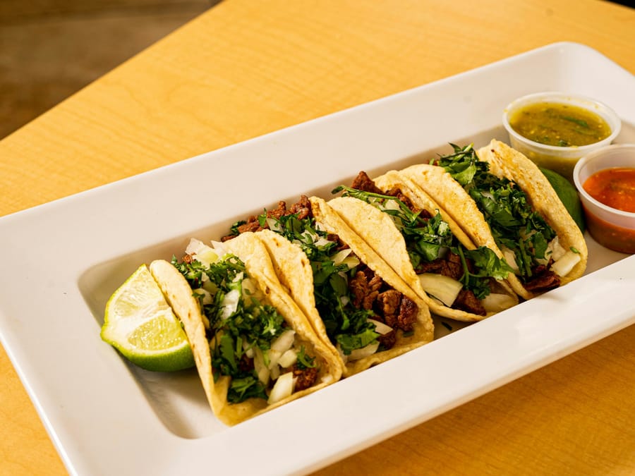 Tacos al Pastor — Hand-pressed corn tortillas, achiote pork, grilled pineapple