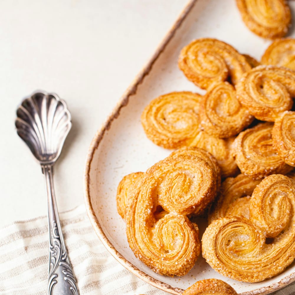 Freshly baked kouign-amann with deep caramel crust on a white linen cloth