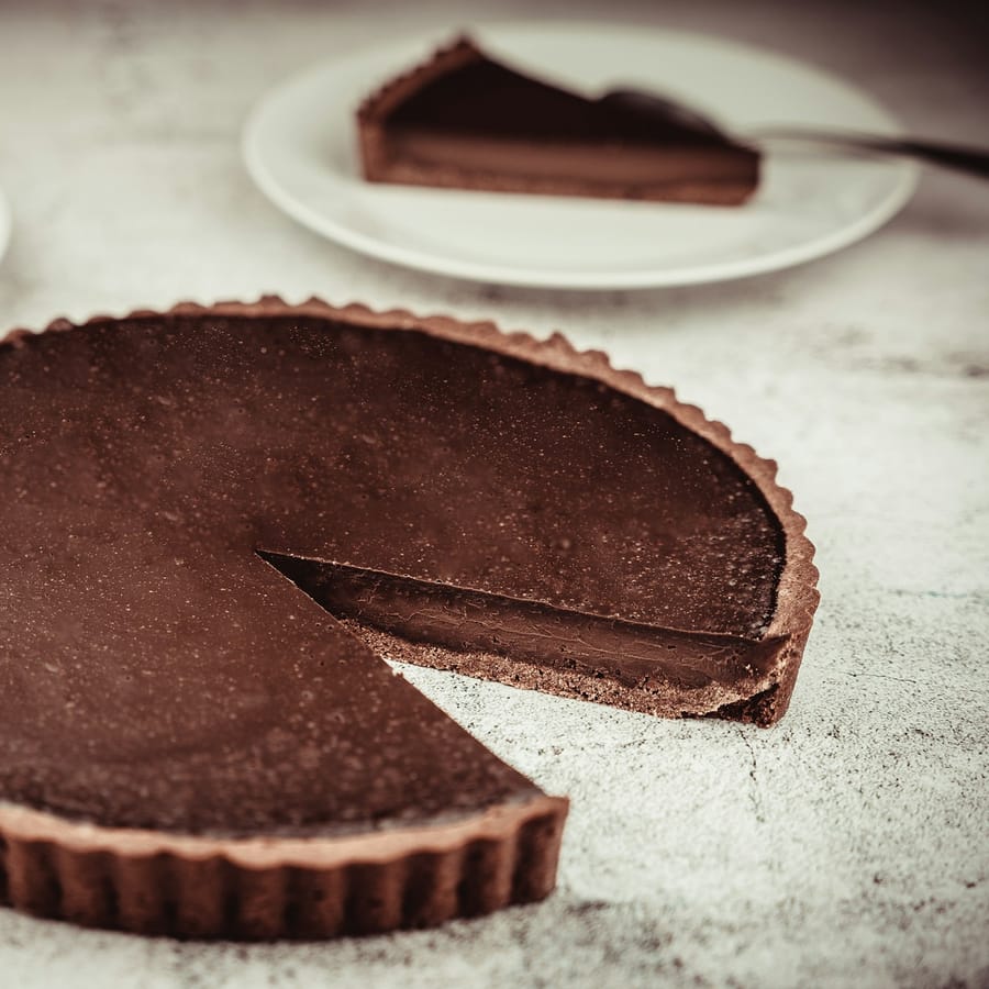 Dark chocolate tart with fleur de sel and raspberry coulis