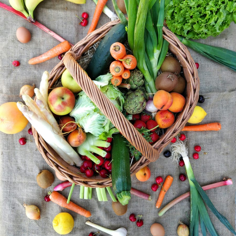 Farm-fresh seasonal vegetables arranged in a wicker basket