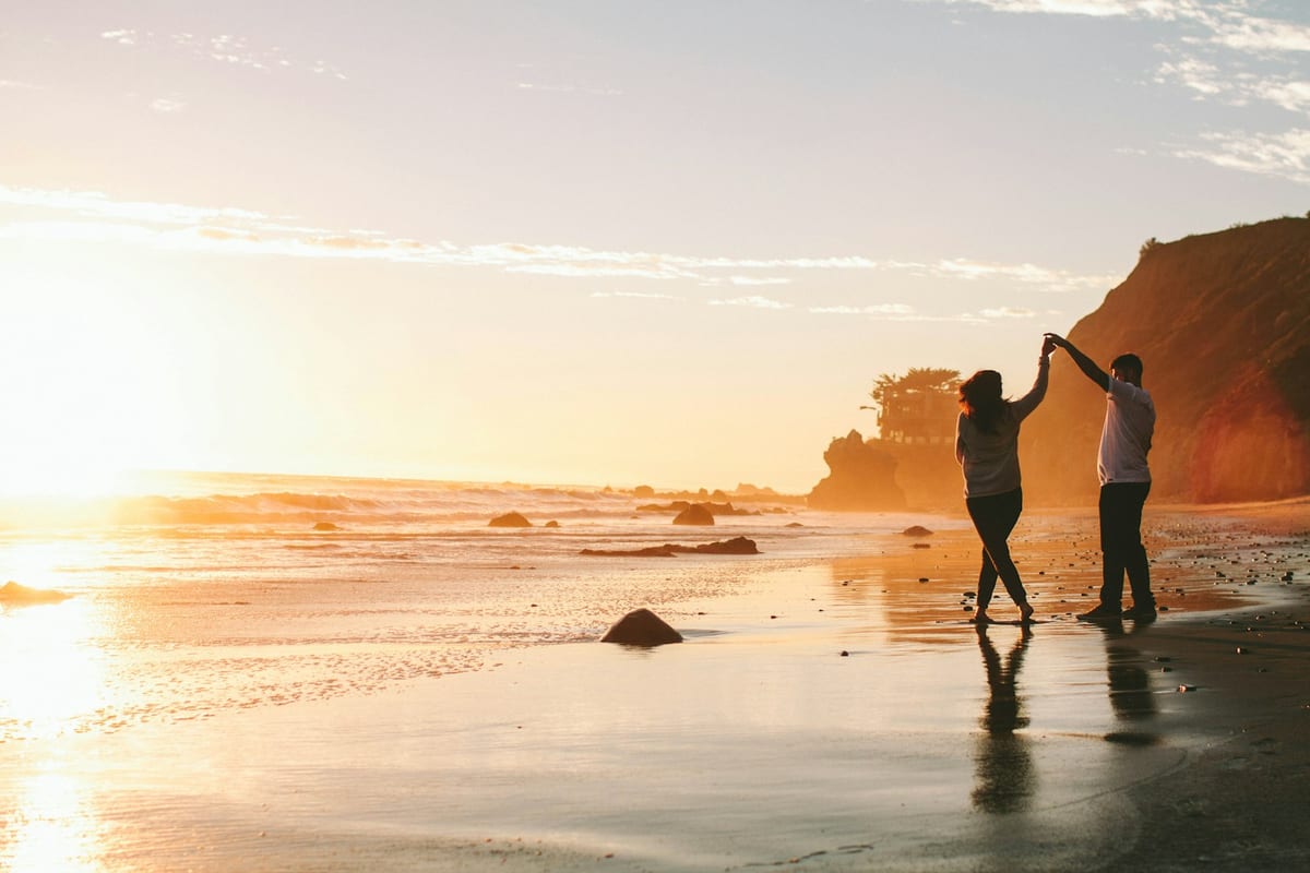 Emma and James at sunset on the beach
