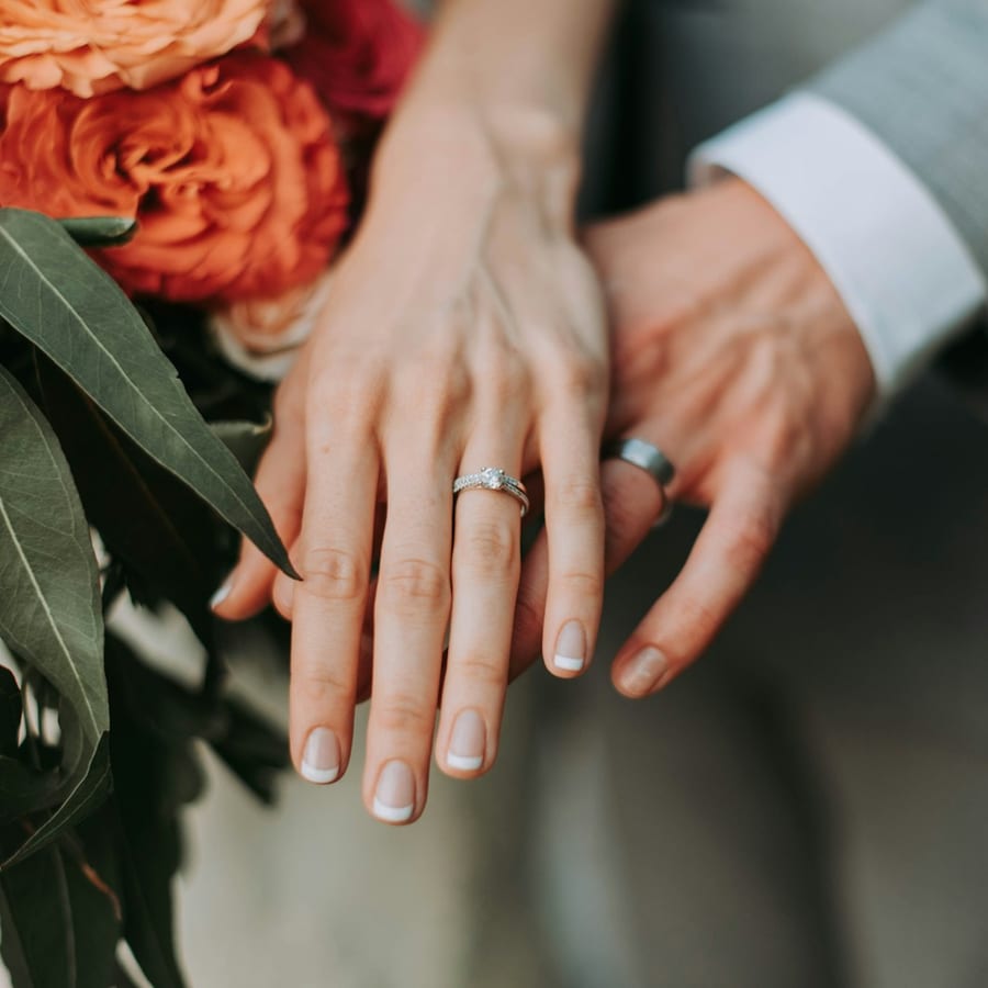 Hands with engagement rings