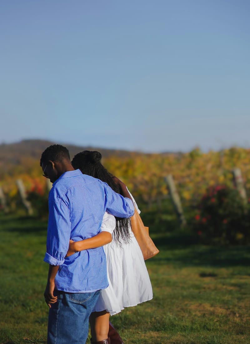 Emma and James in a sunlit vineyard