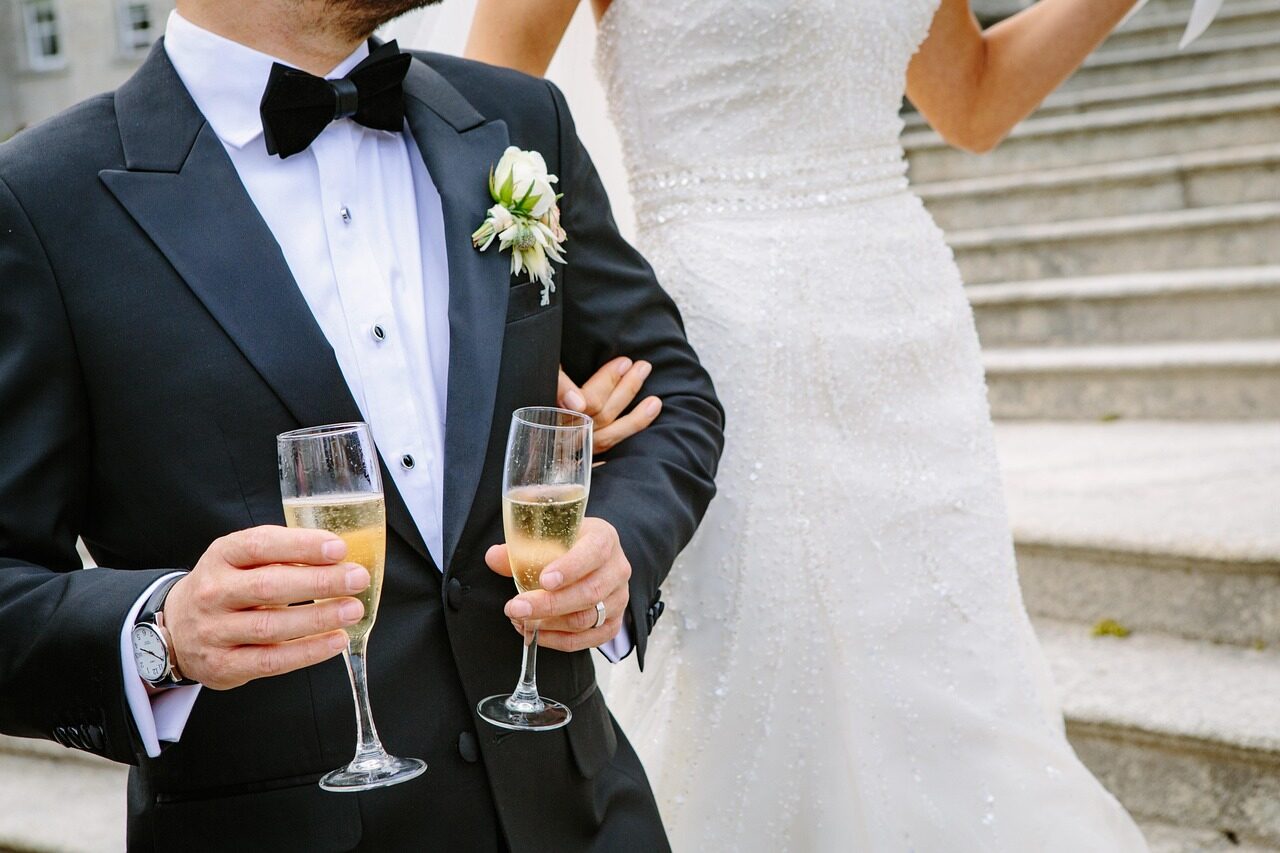 The couple holding champagne flutes, photographed close