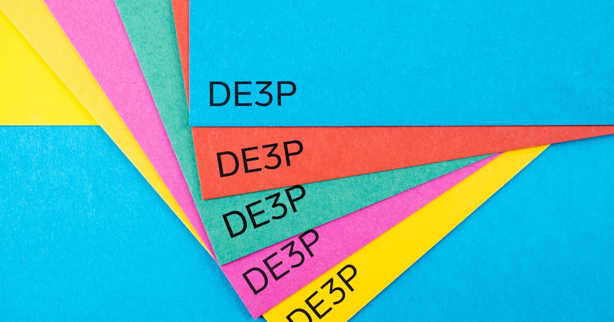 A close up of four different colored papers