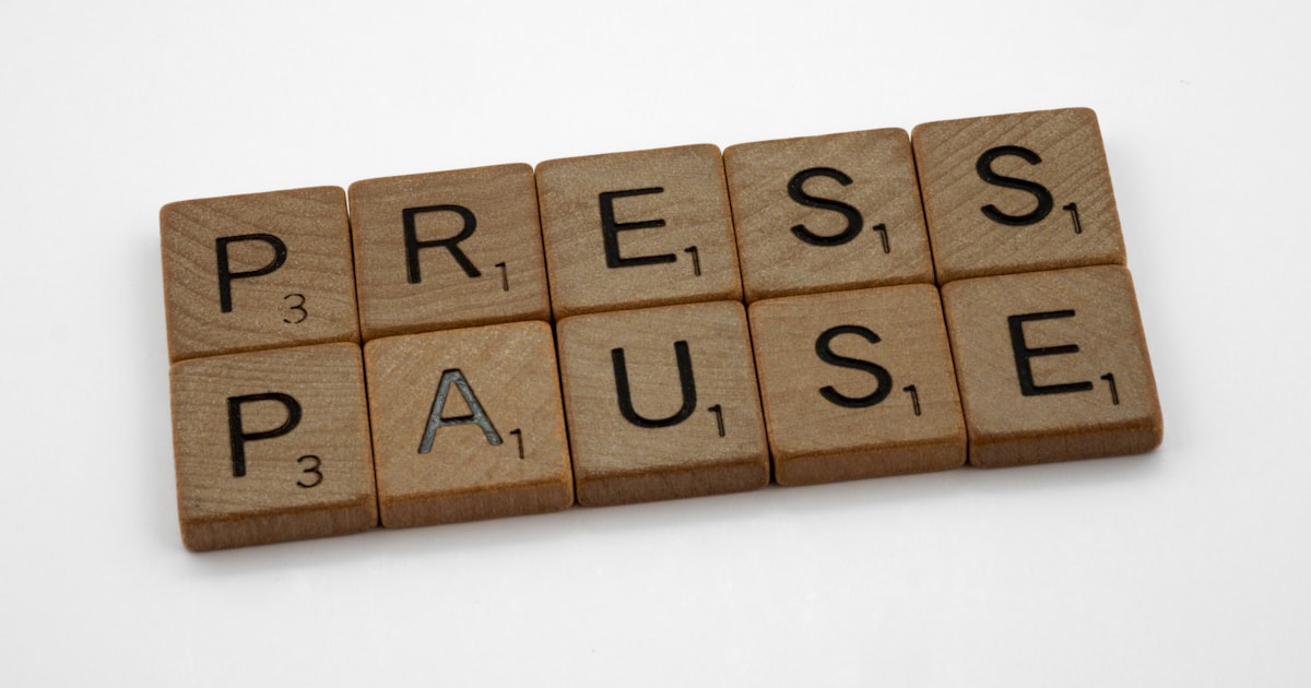 A scrabble of words spelling press pause