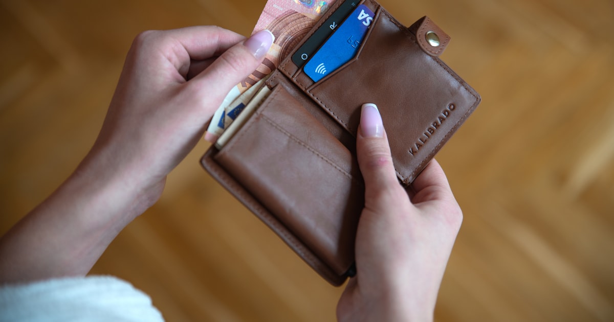 Holding a leather card wallet