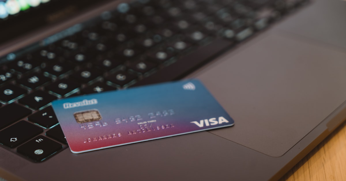 Blue and white visa card on silver laptop computer