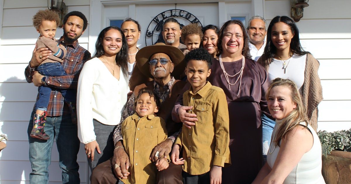 A group of people standing near a white building