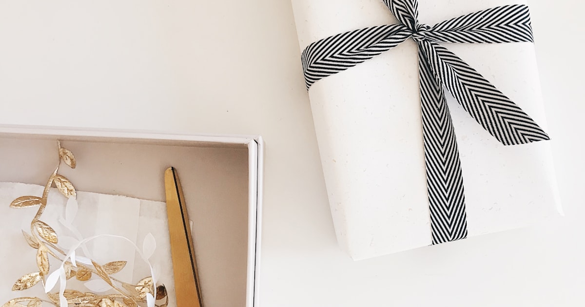 Black scissors on a gift box