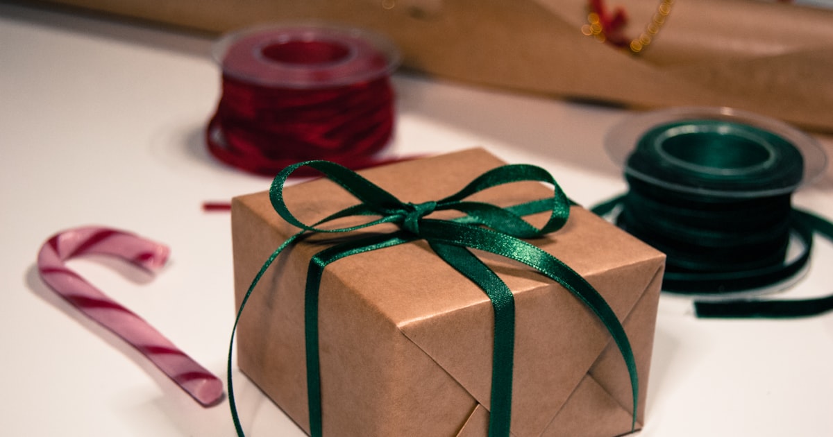 A green and white wrapped gift with green ribbon