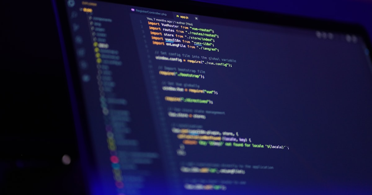 A laptop screen displaying colorful code