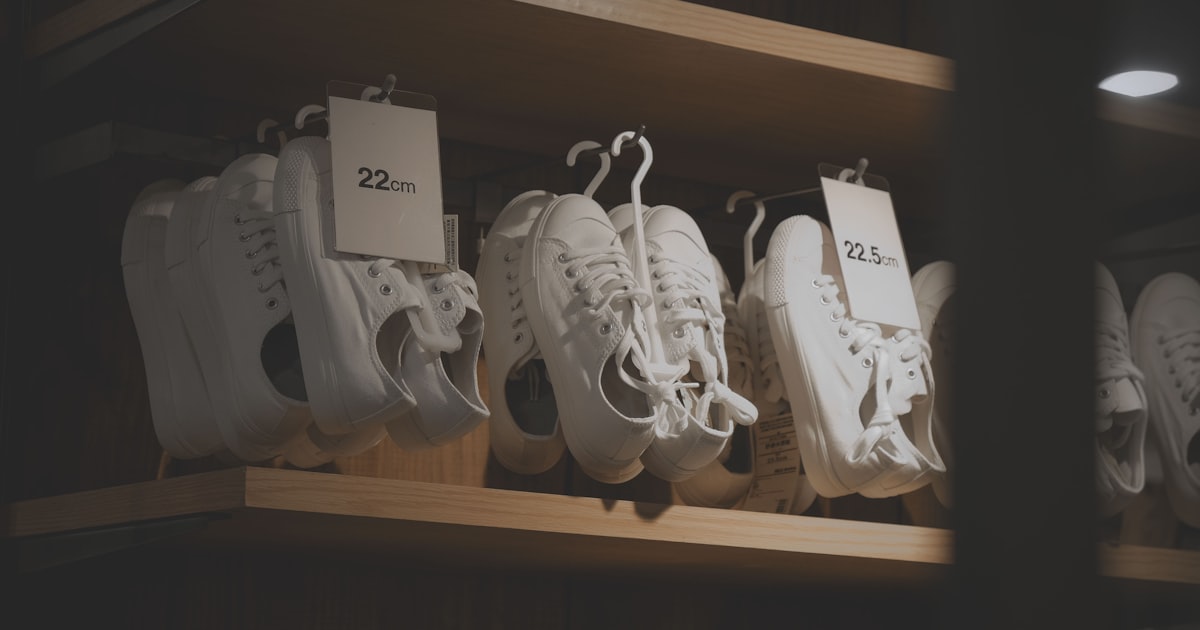 Pile of white sneakers with price tags