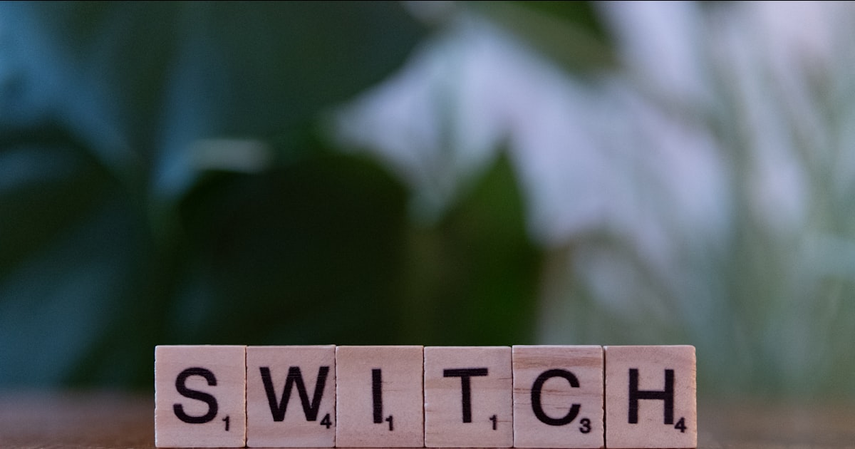 A wooden block spelling switch on a table