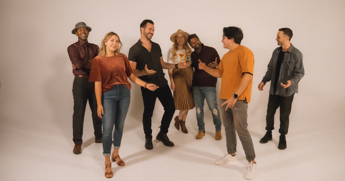 A group of people standing on a white floor