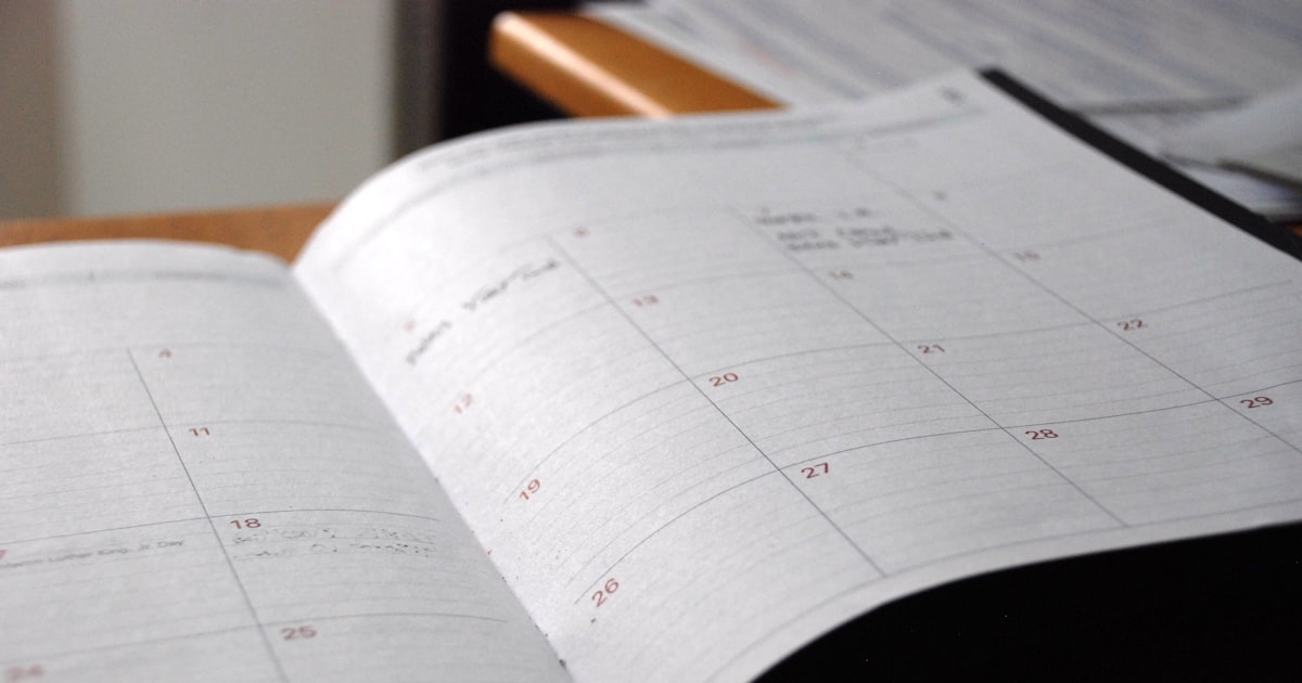 Open monthly planner on wooden desk